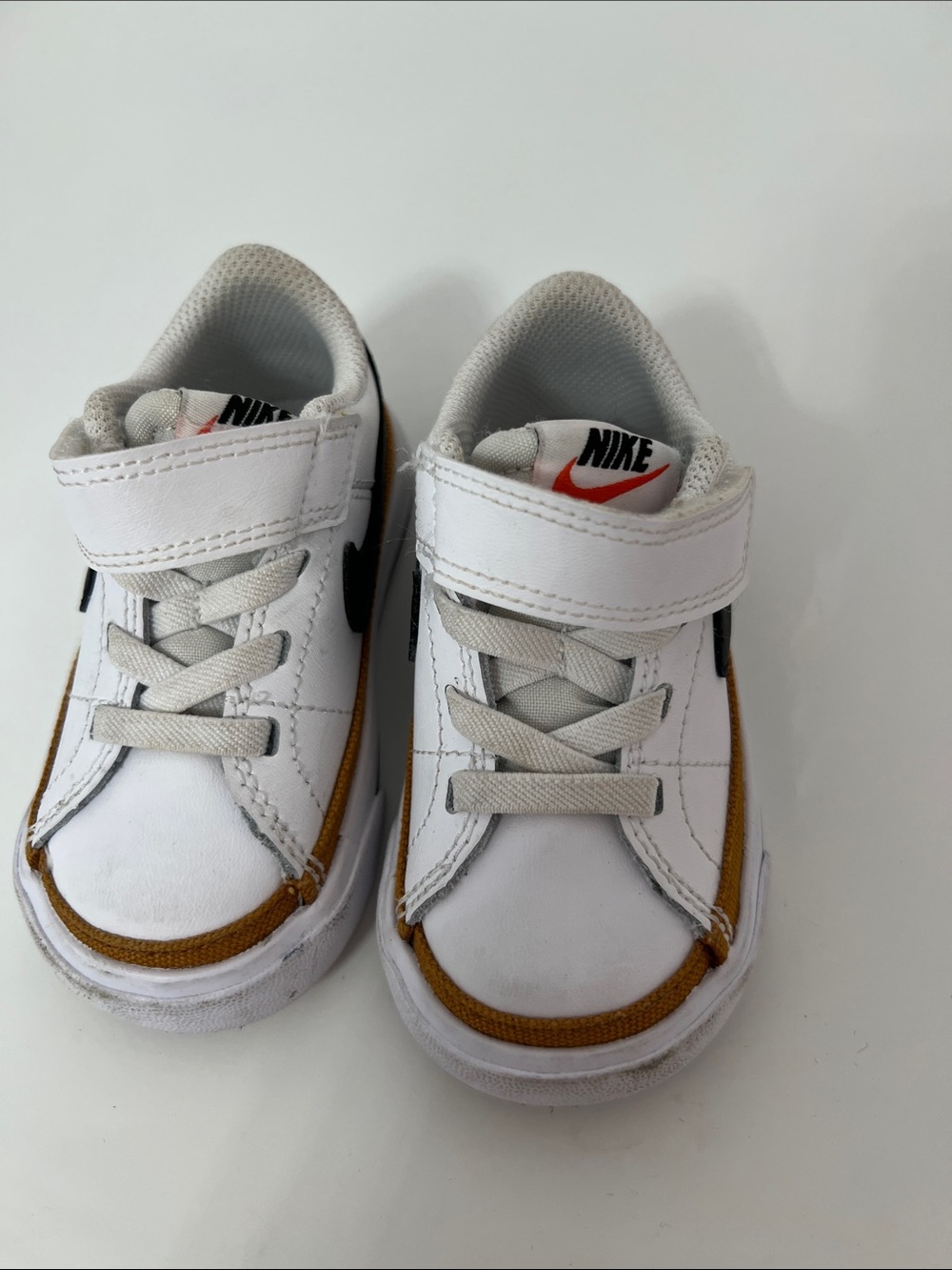 Nike Kids White Sneakers with Brown Trim and Black Swoosh